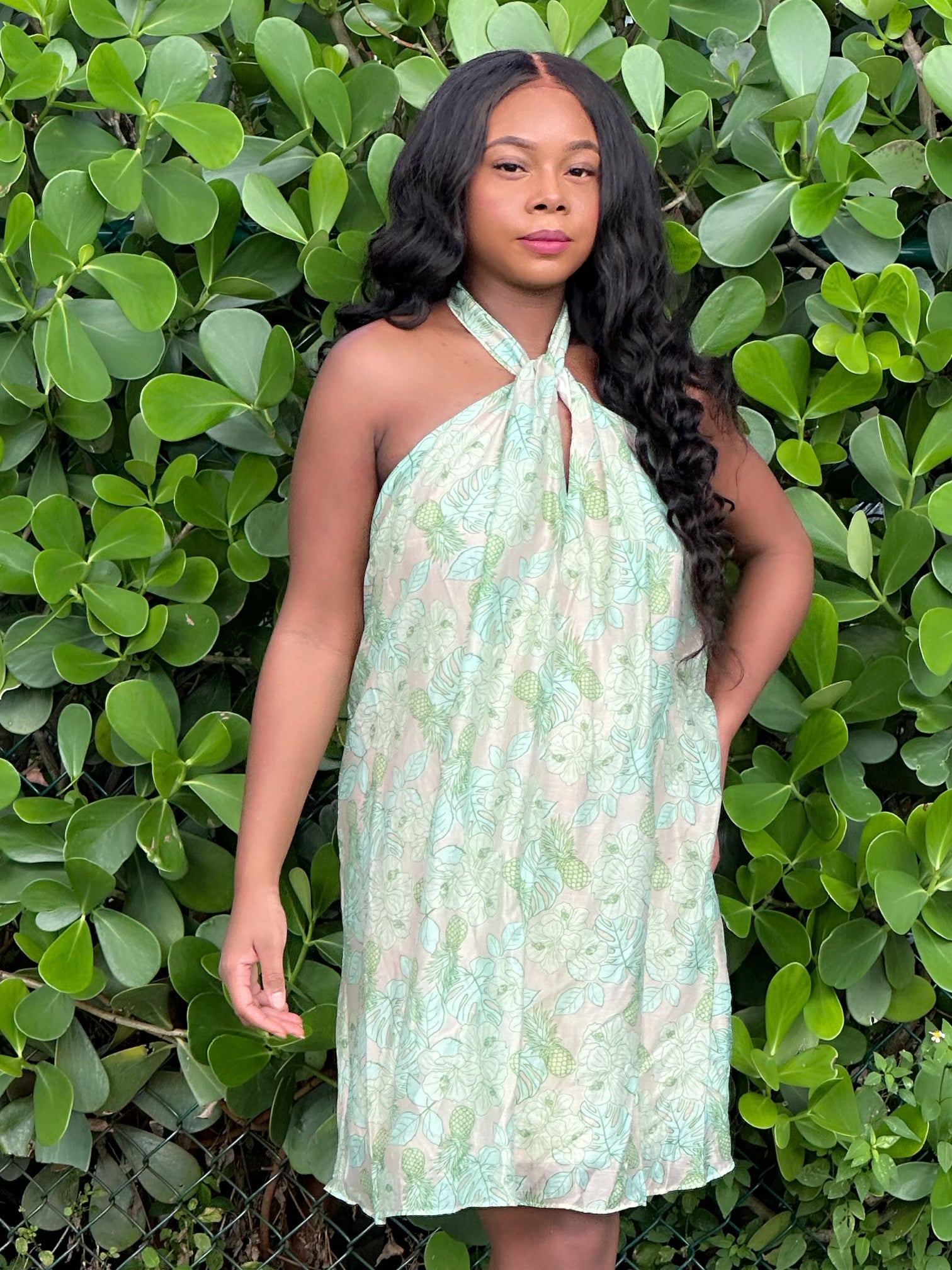 Au Natural Dress featuring a halter neckline and vibrant leaf print, styled for a chic girls' outing. Mini dress with excellent stretch and soft fabric.