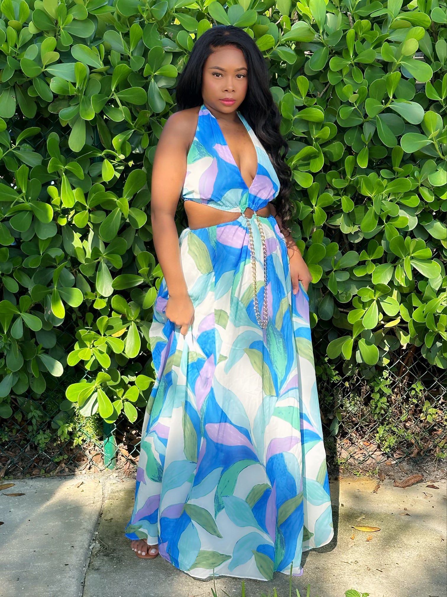 Blueberry Swirl Maxi Dress with bold swirl prints in blue, green, and purple tones, featuring a halter neckline and waist cut-out. Trendy urban-chic women’s dress perfect for summer and parties.