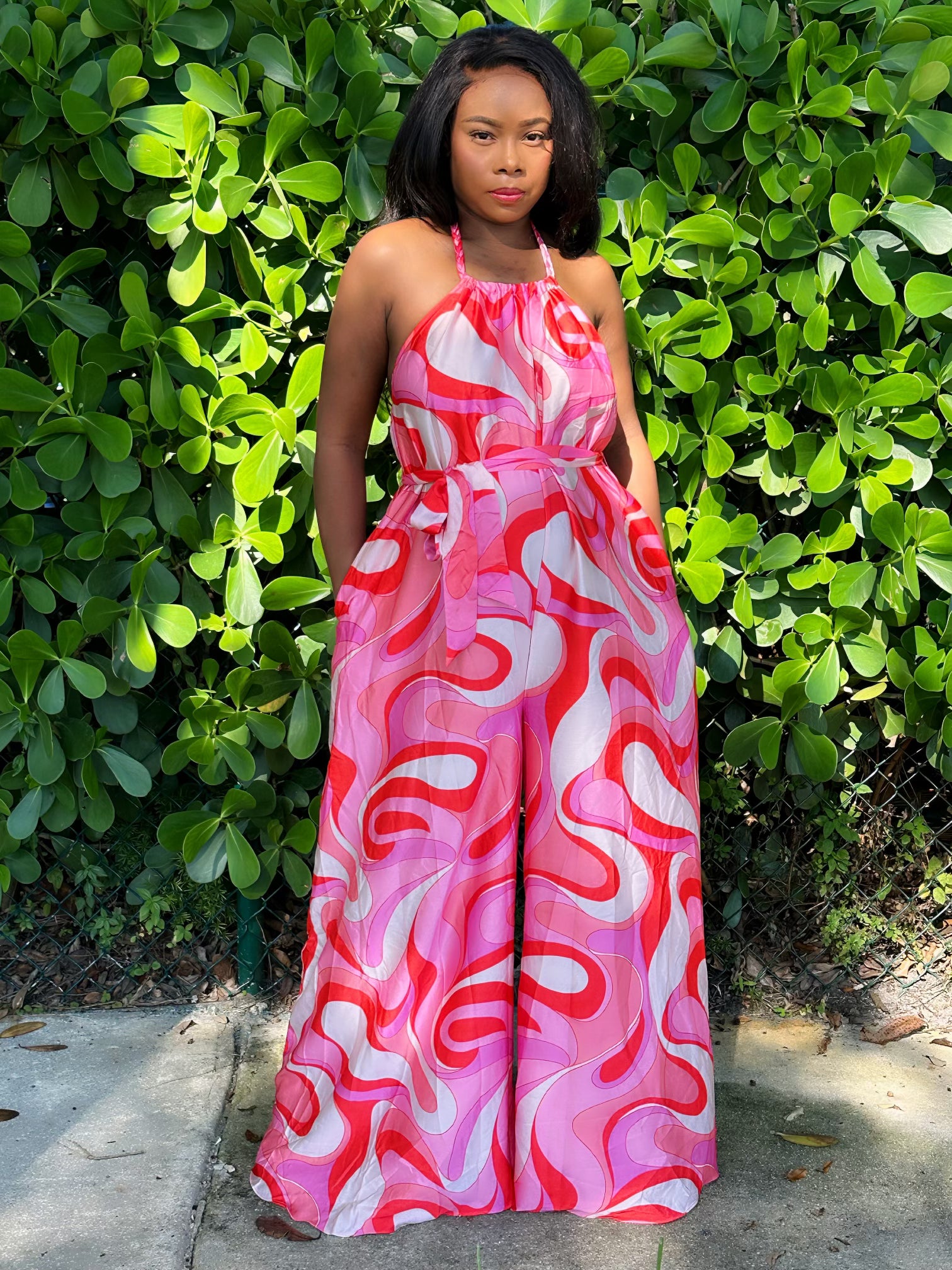 Trendy pink swirl jumpsuit styled for urban chic fashion